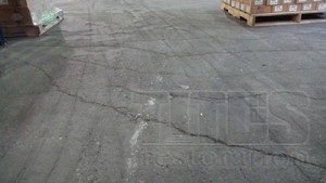 A floor in need of industrial concrete floor repairs typically presents structural cracking and deterioration. 