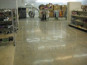 A polished concrete floor shines in a retail space as a perfect alternative to VCT flooring