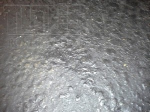 This close up image of a raised aggregate concrete floor shows a common problem in industrial warehouse floors.